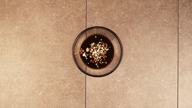 Person adds garlic to marinade