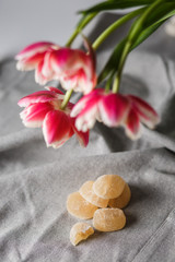 Fototapeta na wymiar Marmalade and tulips on the gray background
