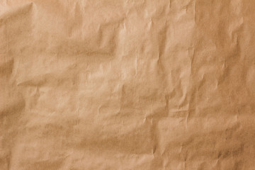 Kraft paper texture. Crumpled sheet of brown paper.