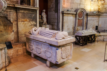 Lisbon, Portugal Carmo Chruch Convent stone sarcophagi exhibits. Gothic style stone casket sarcophagi with carvings in Carmo Monastery Museum at The Convent of Our Lady of Mount Carmel - obrazy, fototapety, plakaty