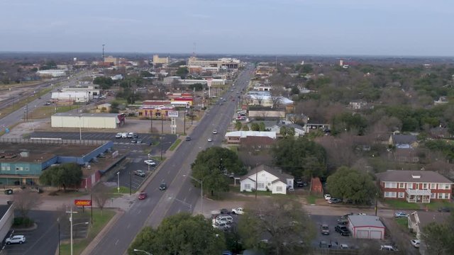 AERIAL: small town street traffic view panning