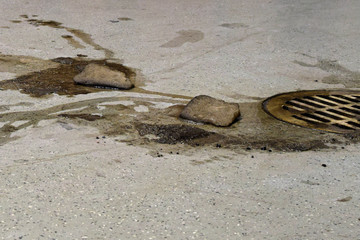 Dirty snow from car melting on garage floor to drain.