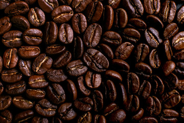 Fragrant coffee beans on rustic tabletop background. Banner copy space.