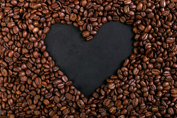 Aroma roasted coffee beans on rustic tabletop, brown banner background, shape of a heart.