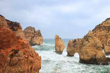 Fototapeta na wymiar Stone formations in the ocean at Ponta De Piedade tourist destination in Algarve, Portugal. 