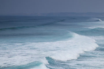 Waves at Praia Da Bordeira beach in southern Portugal in Algarve region crashing. Perfect for surfing. 