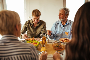 Happy family having lunch together at home