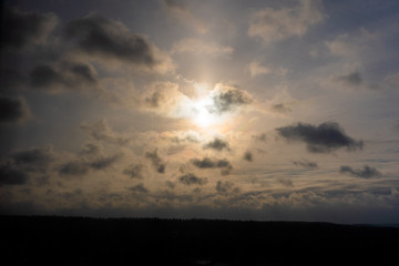Dramatic sky with clouds and the sun