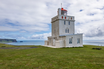 Fototapeta na wymiar The old lighthouse on a Dyrholaey cape in south region of Iceland