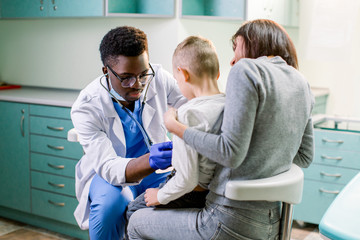 Fototapeta premium Woman with her son visiting children's doctor in hospital