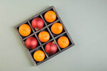 tangerines and Christmas decorations in a wooden matrix box