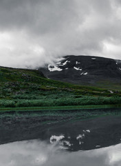 Mountain reflection in the water at the lake outside Alesjaure mountain station at the hike of Kungsleden (Kings trail) in northern Sweden. 