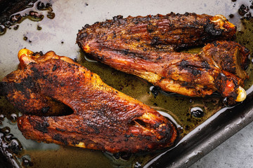 Baked duck with oranges in the oven on a pan, top view