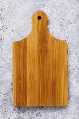 Empty beech cutting board on the table, top view. Food background