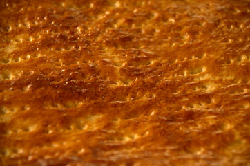Tasty surface: golden brown colors of an apple cake
