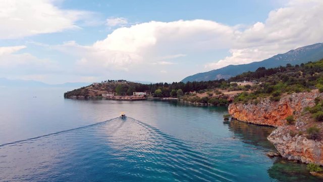 Aerial shot of Macedonia coast. Clif and beautiful water around Ohrid Lake in Southern Europe with view of Pesztani and Trpejca and Bay of Bones