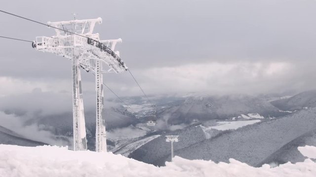 Gondola Lift in the Chleb mountains overlooking a snowy, beautiful landscape.
