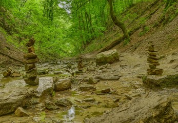 Stream and a stone tower in a forest