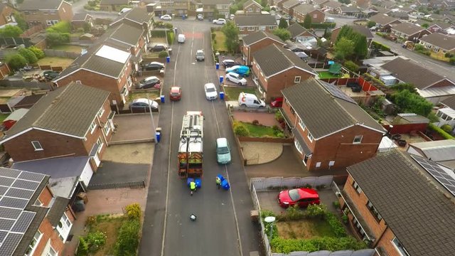 Aerial View, footage of Dustmen putting recycling waste into a garbage truck, Bin men, refuse collectors. bin lorry, Recycling day, Video No1 of 8