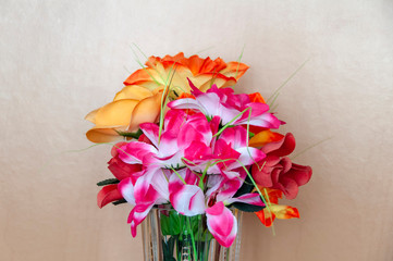 bouquet of flowers in half vase on wooden background