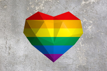 Rainbow heart on the background of a concrete wall. Symbol of sexual minorities and tolerance.