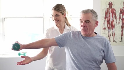 A Modern rehabilitation physiotherapy worker with senior client - Powered by Adobe