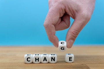 Hand turns a dice and changes the word "CHANGE" to "CHANCE"
