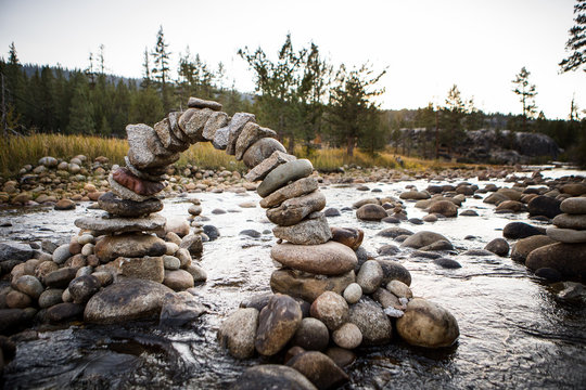 Miniature stone arch in the middle of a stream