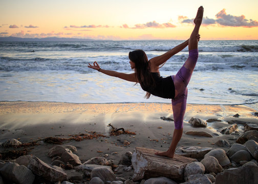 Woman doing a yoga pose on the beach
