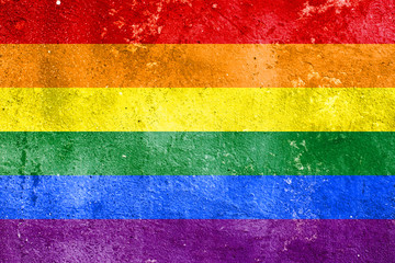 Rainbow flag on concrete wall. Symbol of sexual minorities and tolerance.