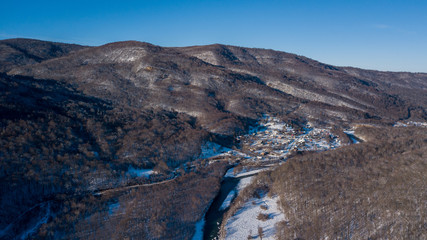 Aerial view of snow capped mountains during sunset. Location place Psebai, Russia.
