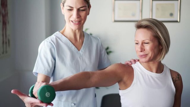 A Modern rehabilitation physiotherapy worker with woman client