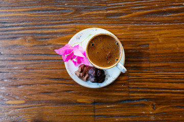 Turkish or Greek Coffee on wooden table from top view. Traditional tasty refreshment hot coffee in coffee cup