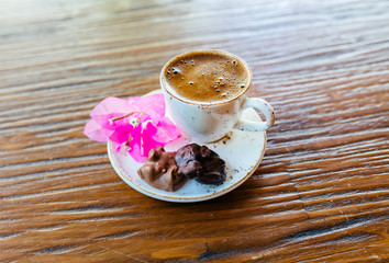 Turkish or Greek Coffee on wooden table from top view. Traditional tasty refreshment hot coffee in coffee cup