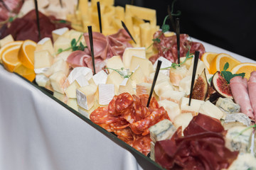 cheese sausage oranges on the table