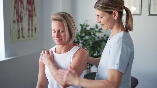 A Modern rehabilitation physiotherapy worker with woman client