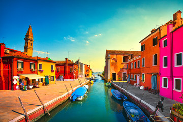Fototapeta premium Burano island canal at sunset, colorful houses, church and boats, Venice Italy