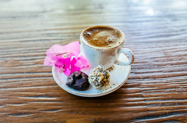 Turkish or Greek Coffee on wooden table from top view. Traditional tasty refreshment hot coffee in coffee cup