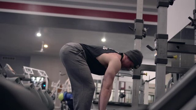 Man lifting weights. Barbell row. Shallow depth of field. 4k