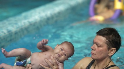 Baby doing exercises in the pool
