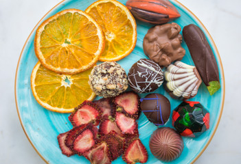 Handmade chocolates or candies and dried fruits in the plate. This is dessert plate and delicious, natural, organic luxury and healthy.