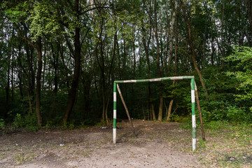 Improvised soccer goalpost on a playground for kids to play sports in a rural forest setting .