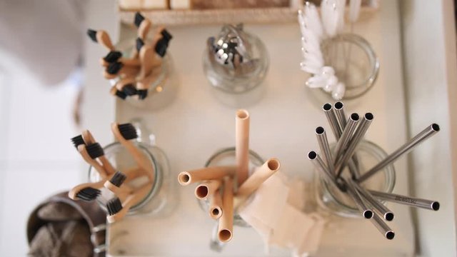 Woman Buying Bamboo Eco Friendly Biodegradable Wooden Cocktail Straw in Zero Waste Shop. No plastic Conscious Minimalism Vegan Lifestyle. Reduce Reuse Recycle 4K Slowmotion Concept.