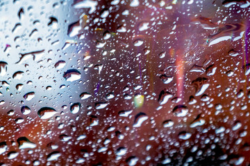 drops reflected in the window with colorful reflections