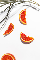 Composition of Sicilian oranges, whole and cut on a white background.