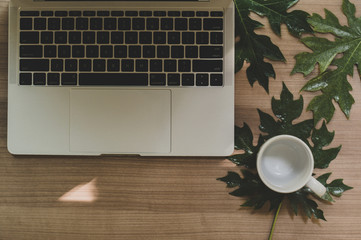 Laptop on a wooden table and a cup of coffee - Images.