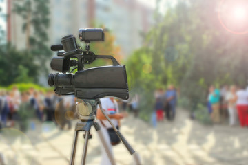 Camcorder Recording people at a party. Selective focus. Blurred people for background, toned