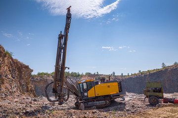 Deep surface drill rig in a quarry open pit mining of granite stone. Process production stone and...