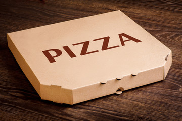 Clean top surface pizza box for your brand with pizza word on the top on a brown wooden table