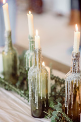 Wedding. Banquet. The chairs and table for guests, decorated with candles, served with cutlery and...